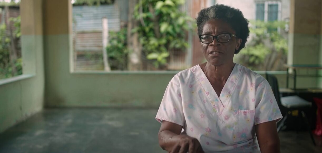 Leona Adolfo, a nursing assistant at Profamilia since 1979, sits in an open space sharing her experiences as a health promoter.